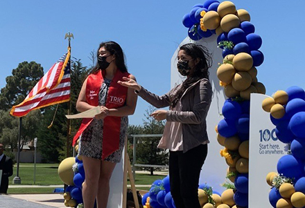 An AHC student walking across the stage at a recognition ceremony.